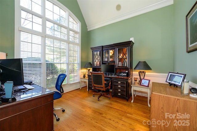 home office with high vaulted ceiling, light wood finished floors, and crown molding