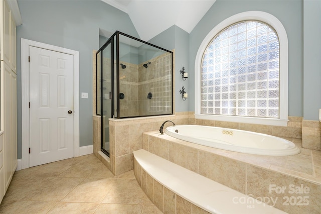 full bathroom featuring lofted ceiling, a shower stall, a bath, and a healthy amount of sunlight