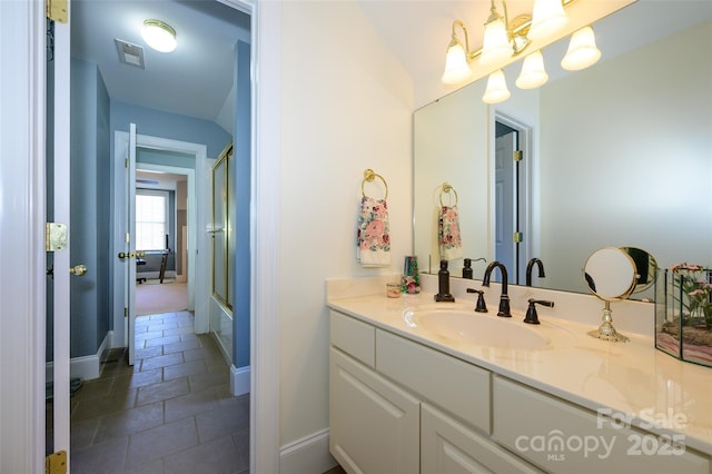 full bathroom featuring visible vents, baseboards, vanity, and stone tile floors