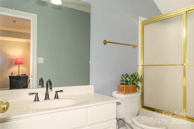 full bath featuring toilet, visible vents, bath / shower combo with glass door, and vanity