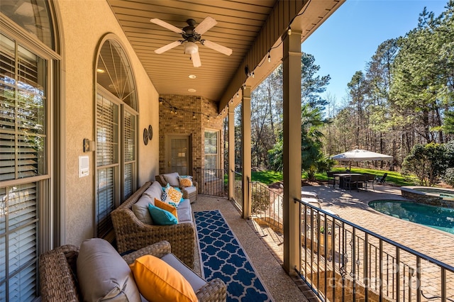 view of patio with a pool with connected hot tub, outdoor lounge area, a ceiling fan, and outdoor dining space