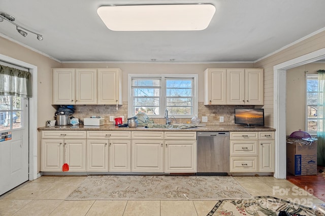 kitchen featuring crown molding, plenty of natural light, dishwasher, and a sink