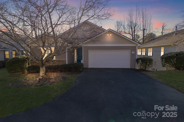 view of front facade featuring driveway and an attached garage