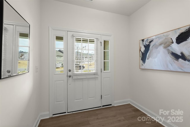 entrance foyer featuring dark wood-style floors and baseboards