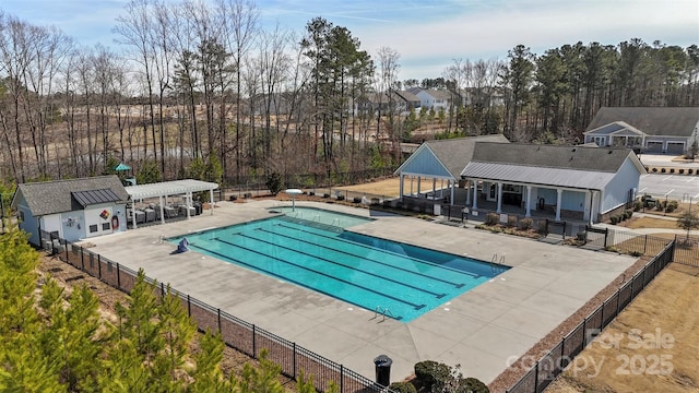 community pool featuring a patio area, fence, and a pergola