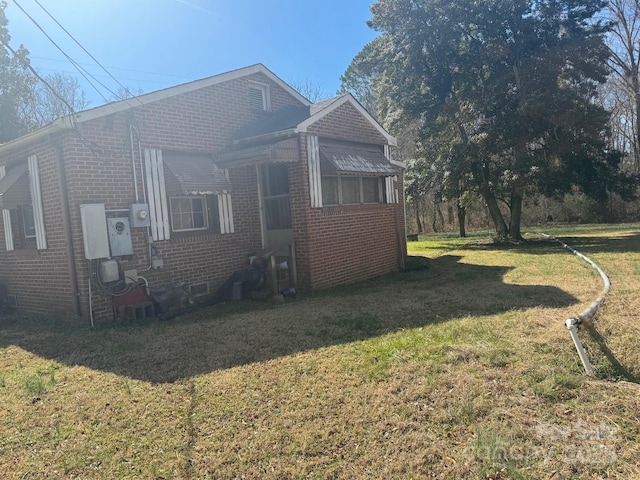 view of front facade with a front lawn, crawl space, and brick siding