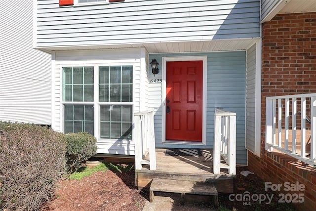 entrance to property with brick siding