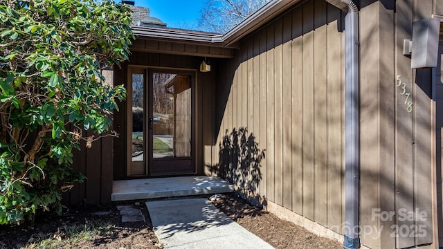 doorway to property featuring a chimney