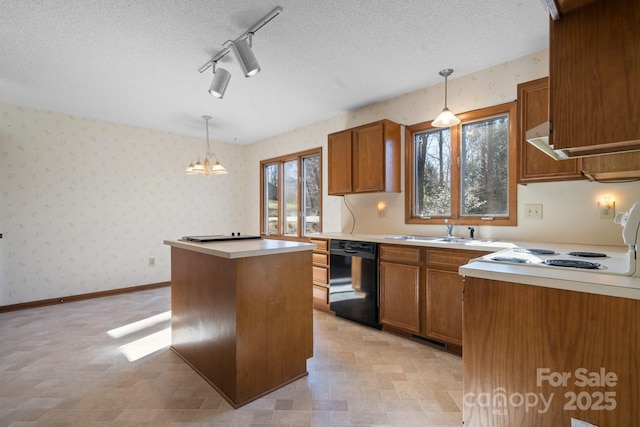 kitchen featuring a kitchen island, light countertops, dishwasher, wallpapered walls, and pendant lighting