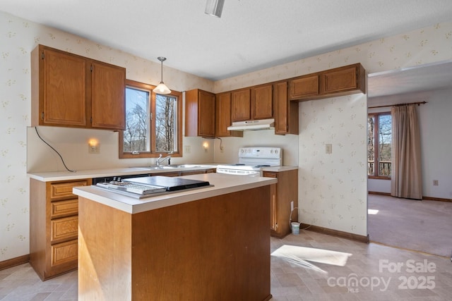 kitchen featuring wallpapered walls, under cabinet range hood, brown cabinets, and white range with electric cooktop