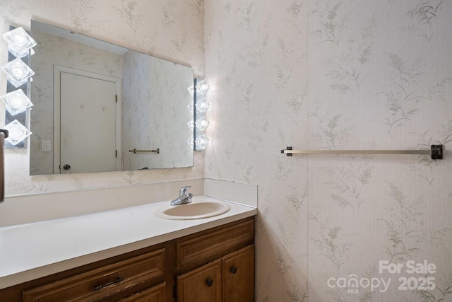 bathroom featuring wallpapered walls and vanity