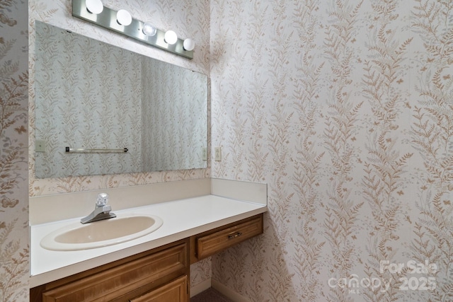 bathroom with vanity and wallpapered walls