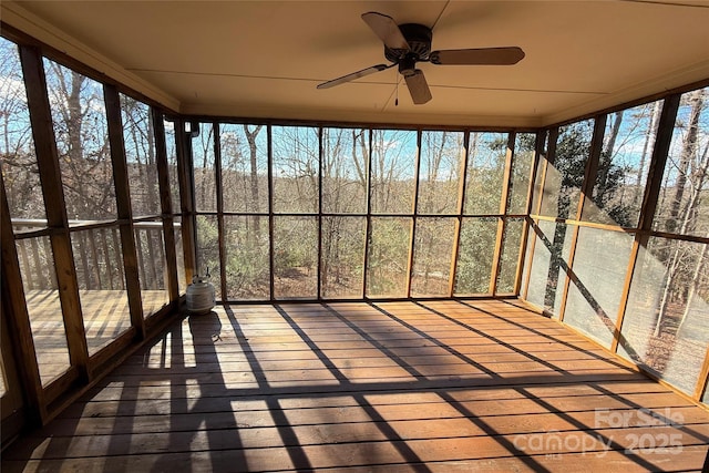 unfurnished sunroom with ceiling fan