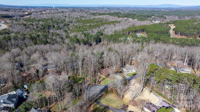 drone / aerial view with a wooded view