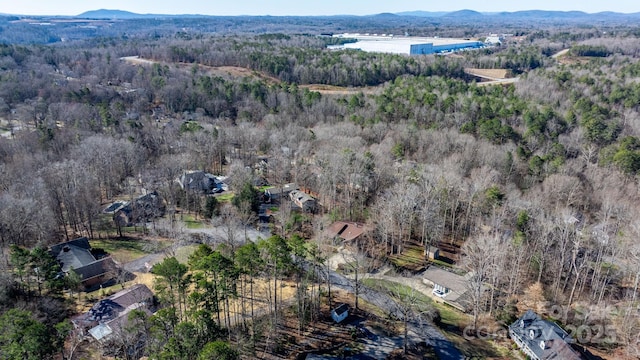 aerial view featuring a forest view and a mountain view