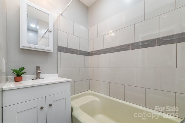 bathroom featuring  shower combination and vanity