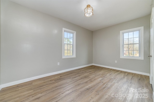 unfurnished room featuring light wood-type flooring and baseboards