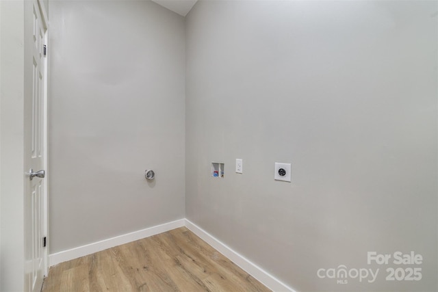 clothes washing area featuring hookup for an electric dryer, laundry area, washer hookup, baseboards, and light wood-style floors