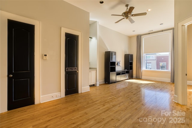 unfurnished living room with recessed lighting, baseboards, a ceiling fan, and light wood finished floors