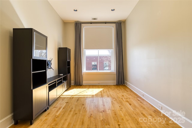 unfurnished living room featuring recessed lighting, visible vents, baseboards, and light wood finished floors