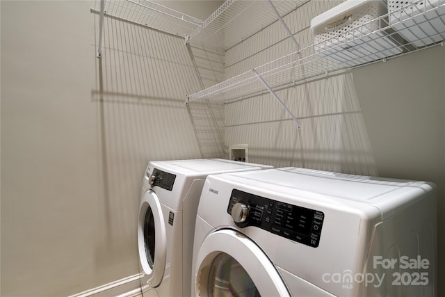 washroom featuring laundry area and washing machine and dryer