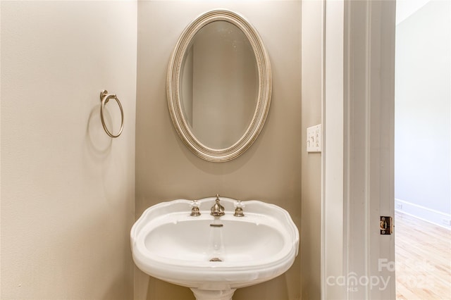 bathroom with a sink and wood finished floors