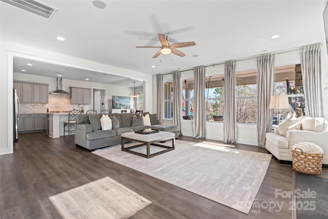 living area featuring dark wood-style floors, visible vents, a ceiling fan, and recessed lighting