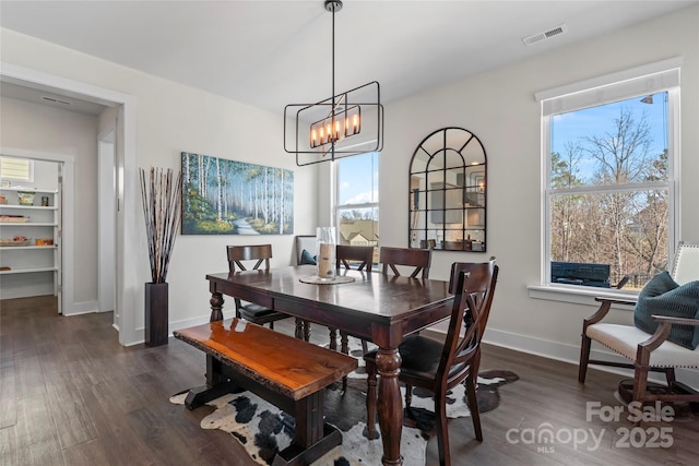 dining room featuring dark wood-style floors, visible vents, plenty of natural light, and baseboards