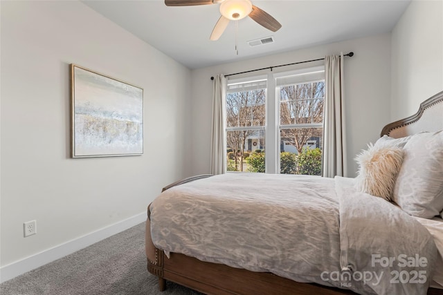 carpeted bedroom with a ceiling fan, visible vents, and baseboards