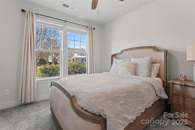 carpeted bedroom with baseboards, visible vents, and a ceiling fan