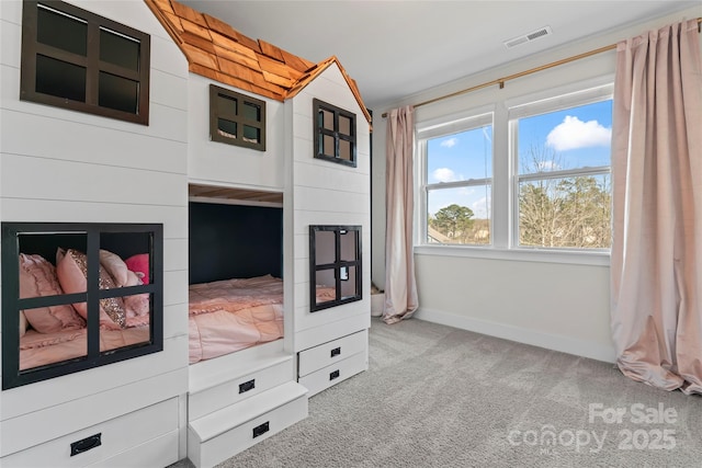 living area with carpet flooring, visible vents, and baseboards