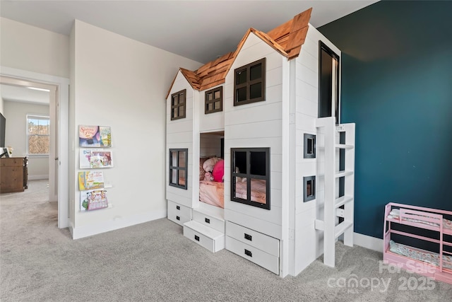 bedroom with carpet floors and baseboards