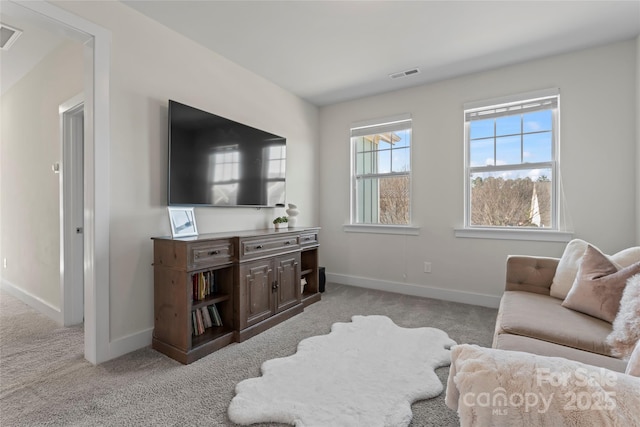 living room with light carpet, visible vents, and baseboards