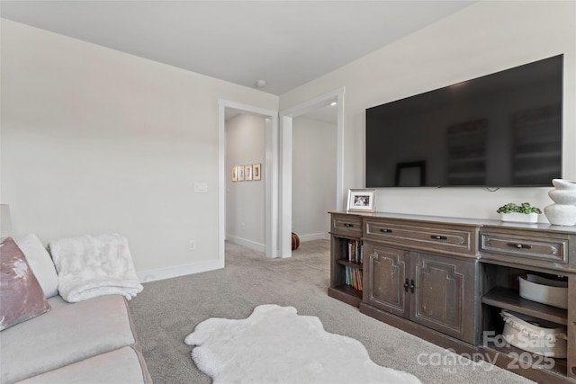 living room featuring light colored carpet and baseboards