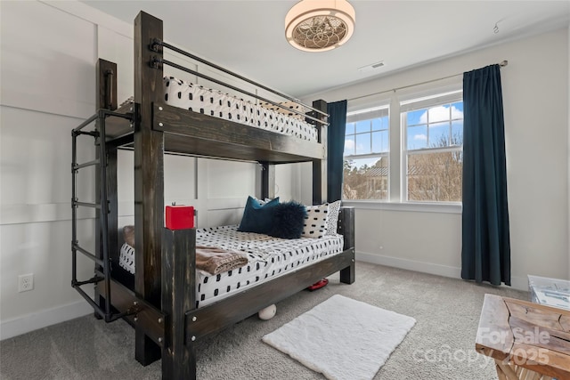 bedroom with carpet, visible vents, and baseboards