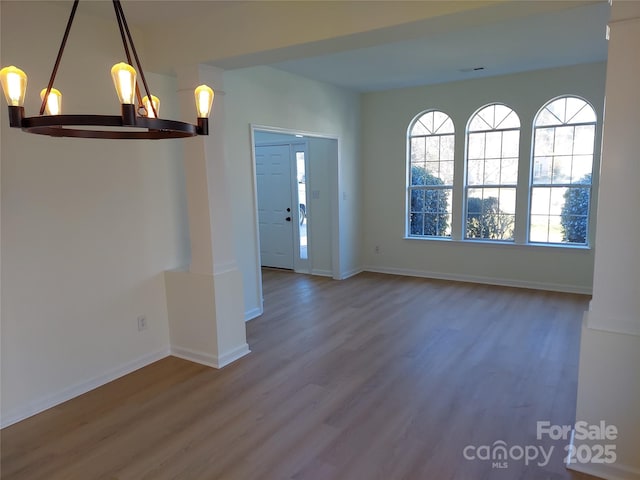 interior space featuring baseboards and wood finished floors