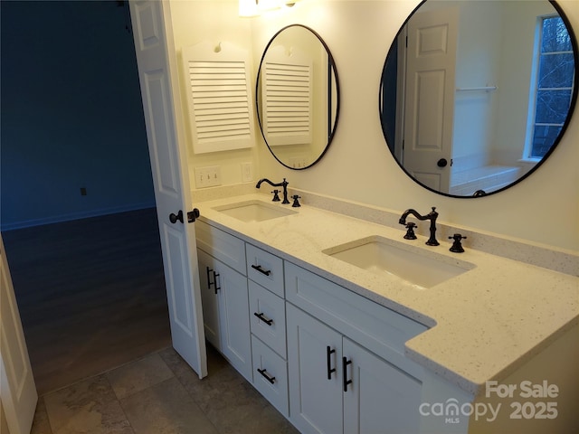 full bath featuring double vanity and a sink