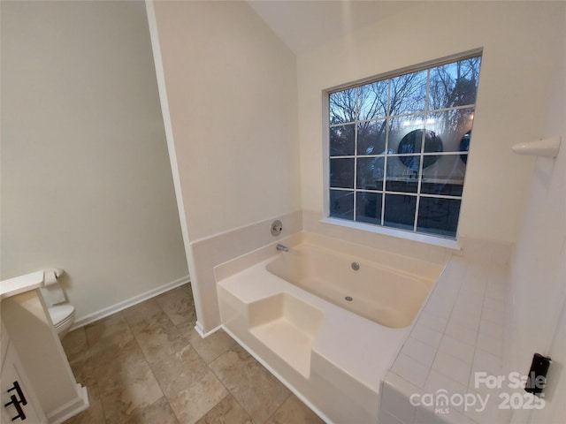 full bath with baseboards and a garden tub