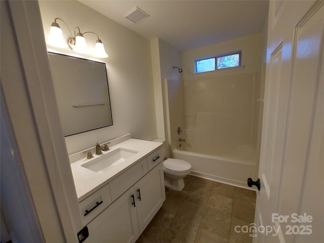 bathroom featuring vanity, toilet, visible vents, and shower / washtub combination