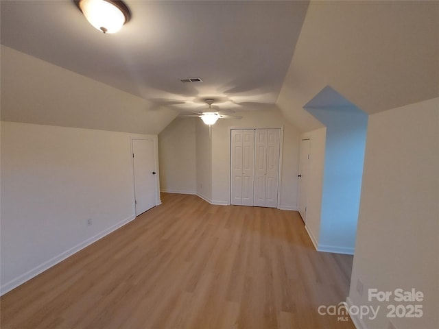 bonus room featuring lofted ceiling, baseboards, visible vents, and light wood-type flooring