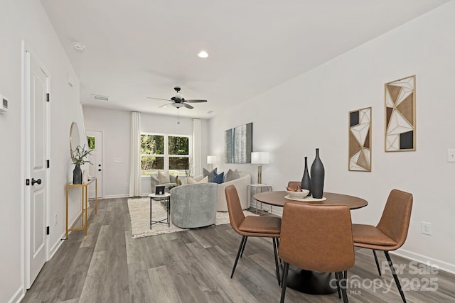 dining area featuring recessed lighting, wood finished floors, visible vents, a ceiling fan, and baseboards