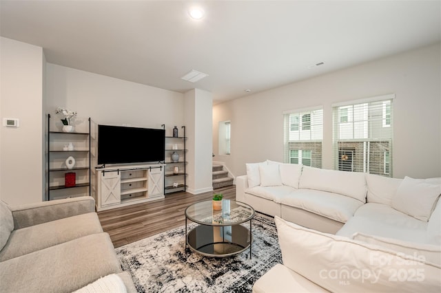 living room with visible vents, recessed lighting, stairs, and wood finished floors