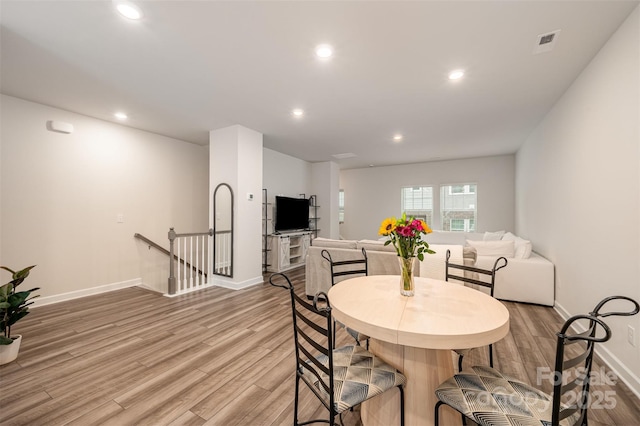 dining area with light wood-style flooring, recessed lighting, visible vents, and baseboards