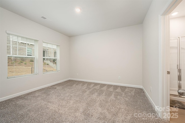 empty room featuring visible vents, recessed lighting, baseboards, and carpet floors