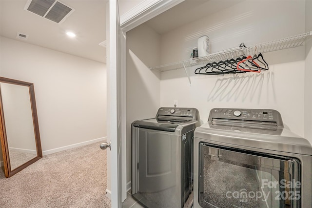 washroom with visible vents, baseboards, carpet flooring, and washing machine and clothes dryer