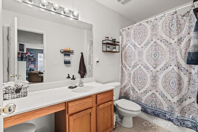 bathroom featuring tile patterned floors, toilet, vanity, and a shower with curtain