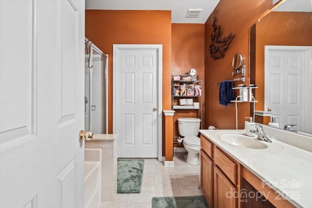 bathroom featuring toilet, a shower with shower door, vanity, and tile patterned flooring