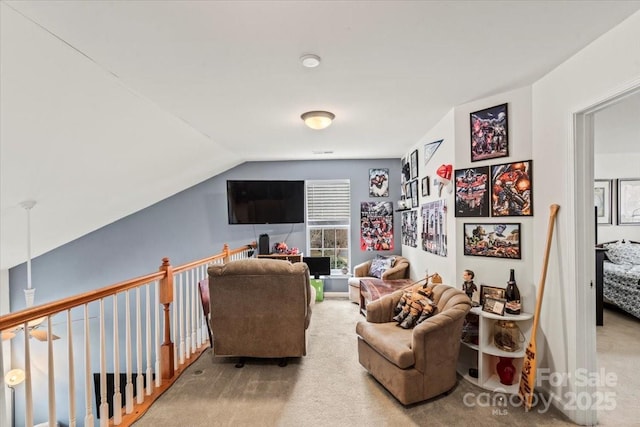 carpeted living room featuring lofted ceiling