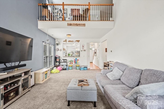 carpeted living room featuring a high ceiling