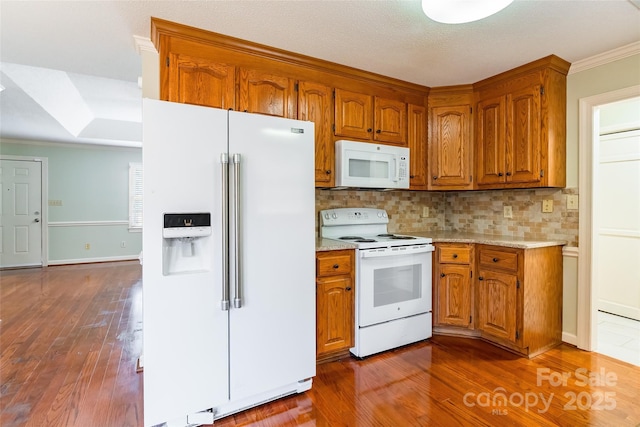 kitchen with backsplash, dark wood-type flooring, crown molding, and white appliances